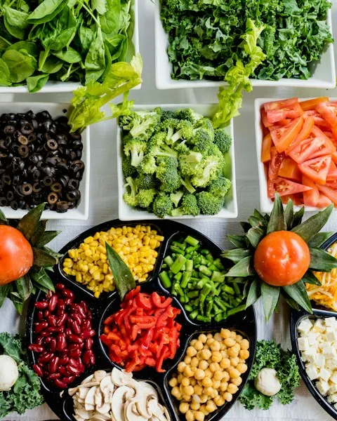 Prepped vegetables and toppings laid out in small dishes