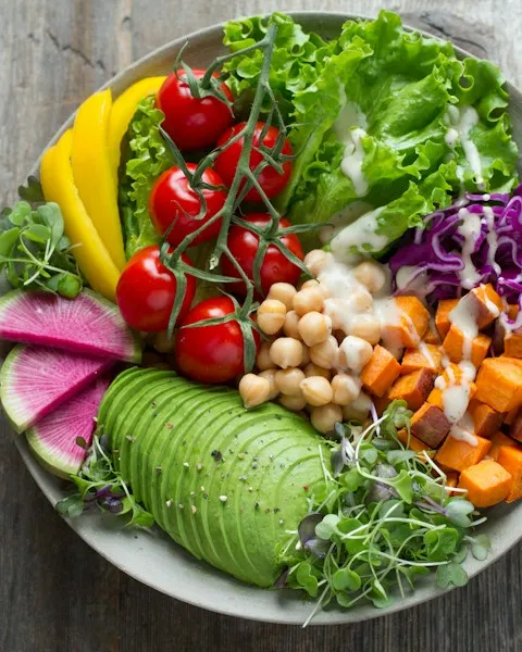 Grain bowl with avocado, chickpeas, and roasted sweet potato