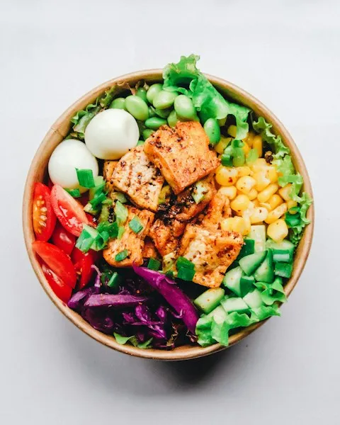 Salad bowl with grilled salmon, egg, and fresh vegetables